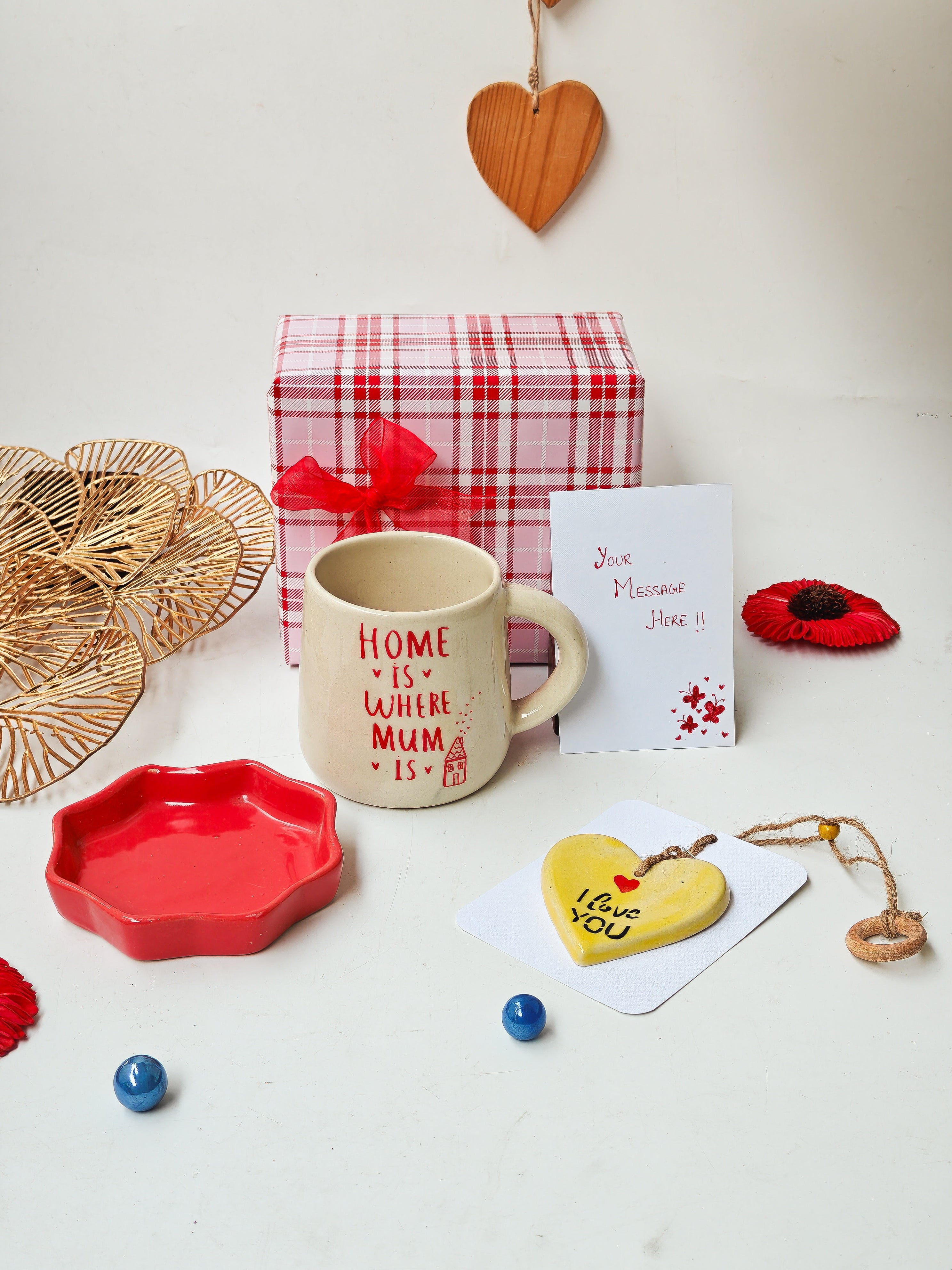 Mug with 'Home is where Mum is' text, gift box, heart-shaped ceramic hanging, and a hand written note for Mom